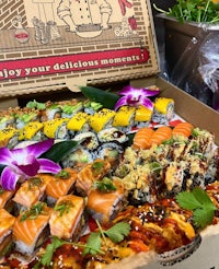 a box filled with sushi and other foods